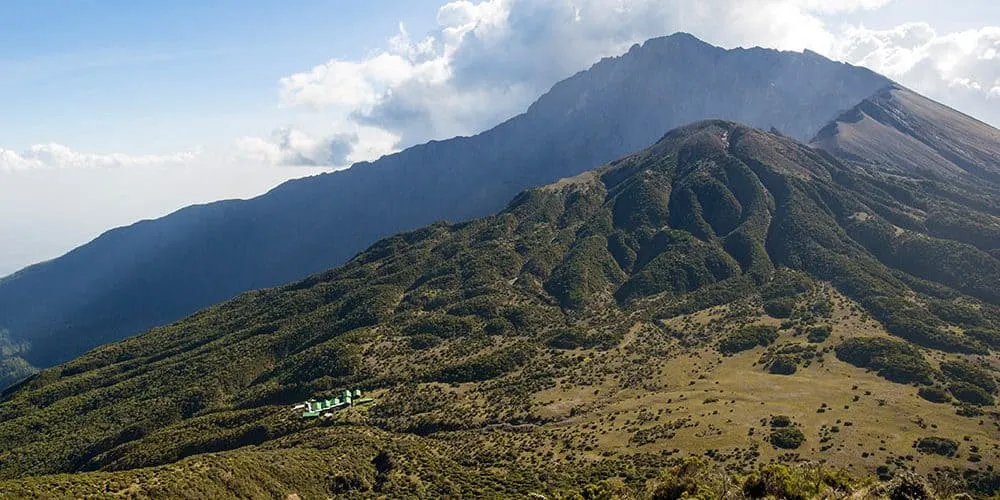 Mount Meru rises above the savanna at golden hour